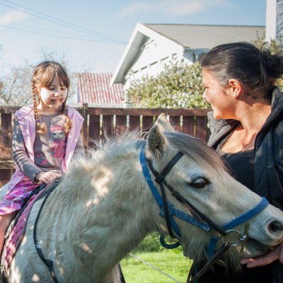 Zoe riding a pony